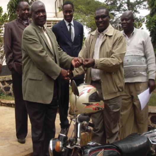 The CNCC Founder, Michael Shirima handing over the motorcycle to the Rombo District Commissioner on the 27th August, 2010